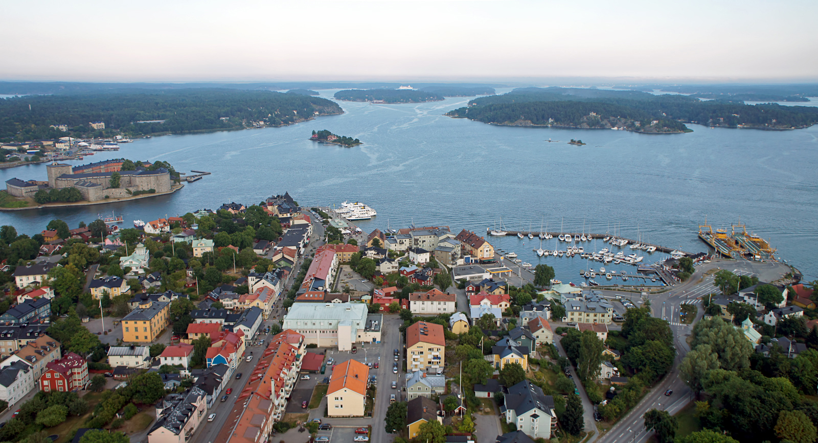  An aerial view of the town of Vaxholm, Sweden, with the Vaxholm Fortress on the left and the main harbor on the right.